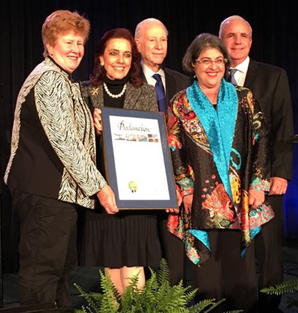 Commissioner Sally A. Heyman, Patricia Frost, Phillip Frost, and Mayor Carlos Gimenez holding the Greater Miami Chamber of Commerce’s “Sand in my Shoes” award.