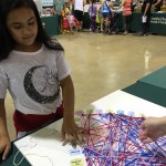 A young guest adds her string to show what she is grateful for.