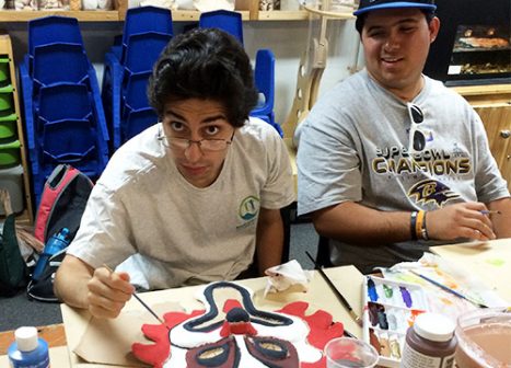 Two young men work on an activity as part of the Nature Links program.