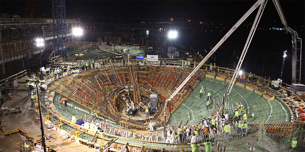 Crews working at night prepare the aquarium for concrete.