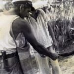 Anthropologist, Charis Crockett, shaking the hands of a native boy.