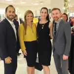 Group of adults posing for a photo at the Badgley Mischka Event