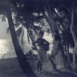 Two native women playing the guitar and singing.