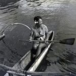 Native woman on a canoe.