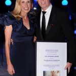 Adults posing for a photo at a gala with theur Frost Science Visionary Award