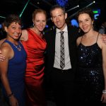 Adults posing for a photo at a gala