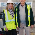 Adults posing for a photo at the construction site.