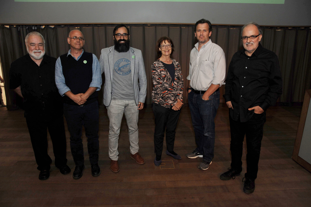 Adults pose for a photo at the screening and lecture of "Experiment"