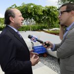 Older man speaking to the press