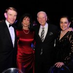 Adults posing for a photo at a gala