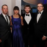 Group of adults posing for a photo at a gala