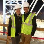 Adults posing for a photo at the construction site.