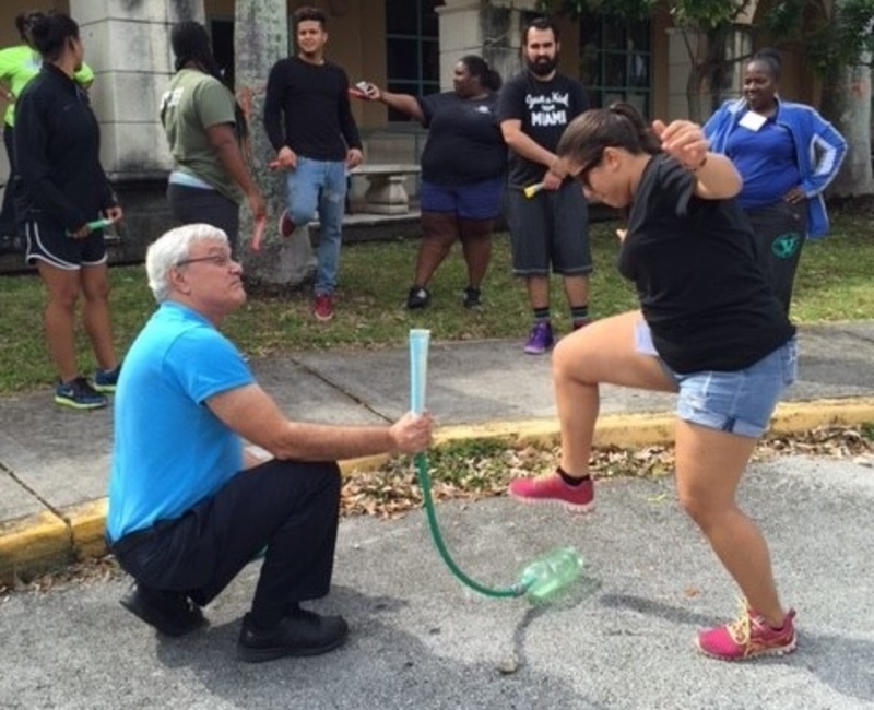 Teacher launches his rocket while his team mates watch from a safe distance at the STEM workshop