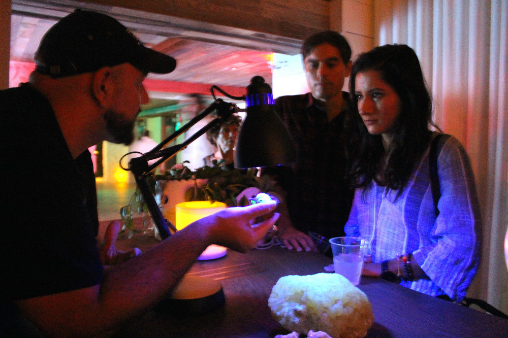 Community Engagement Manager showcases minerals that fluoresce under long-form ultraviolet radiation