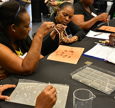 Adult women working on a science experiment