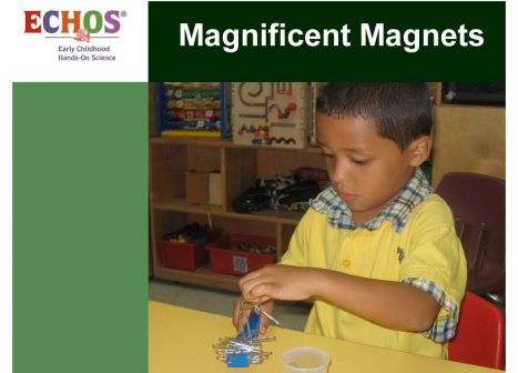 Young boy using magnets and paper clips