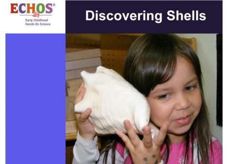 Young girl holding shell to her ear
