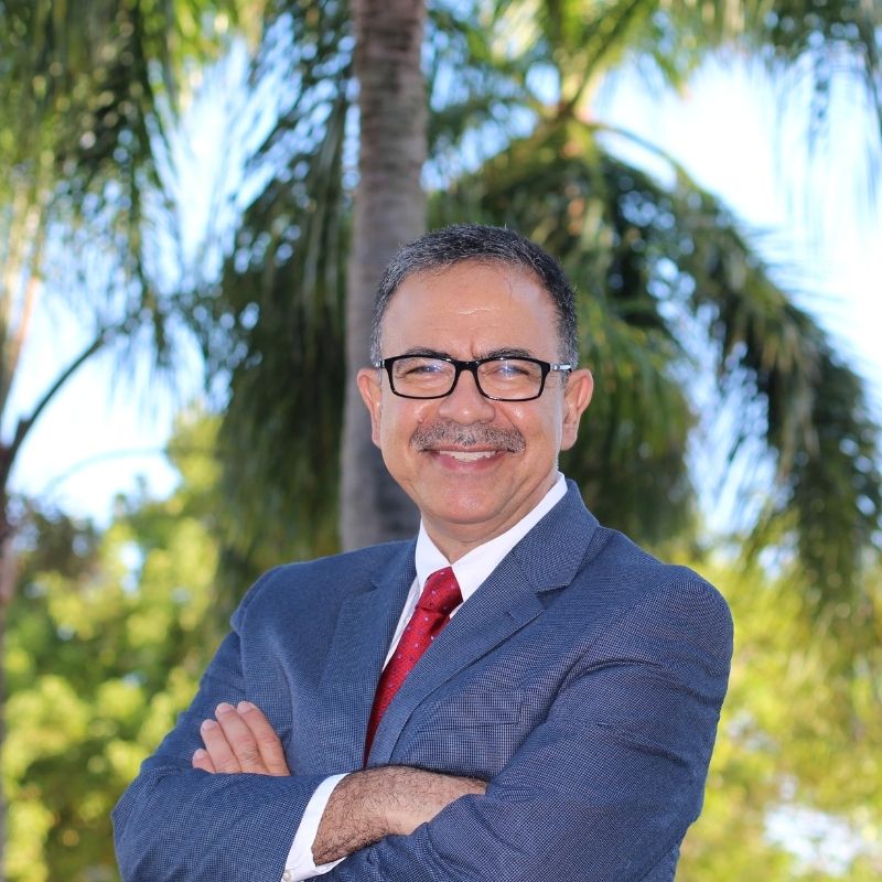 man wearing blue suit and red tie