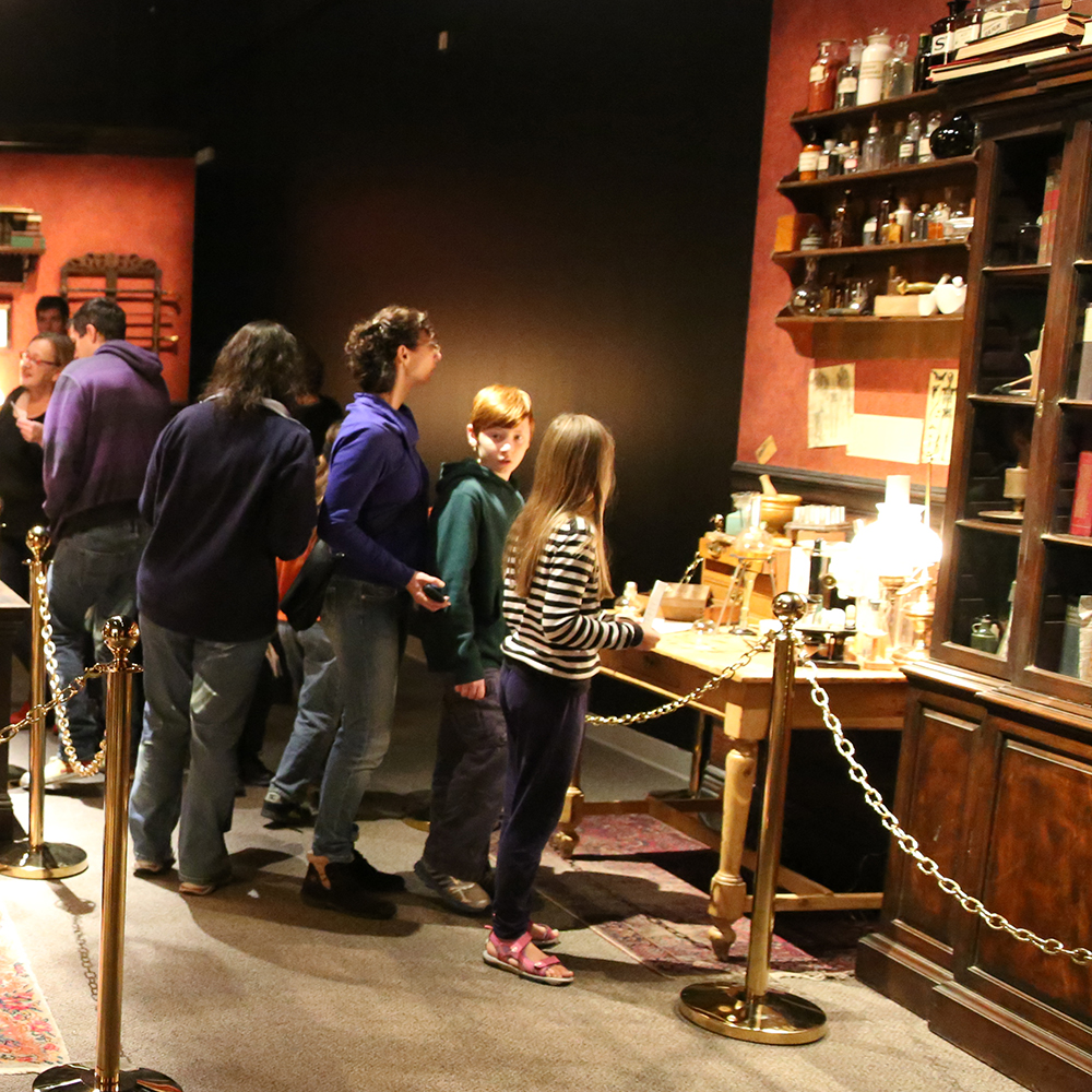 Family looking at an exhibit in Sherlock Holmes exhibition.