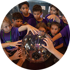 Children touching plasma ball.