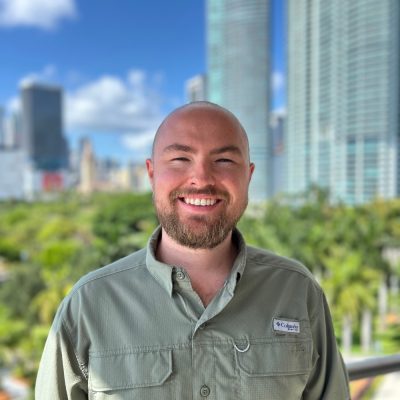 Photo of staff member with view of a park and downtown buildings in the background