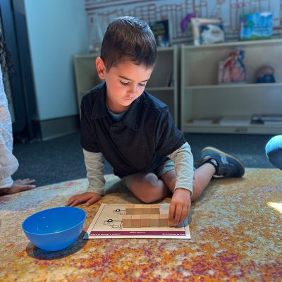 Child engaging in ECHOS blocks lesson.